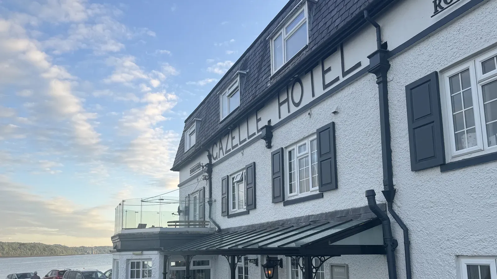 The Gazelle Hotel above the Menai Strait at Glyn Garth, Anglesey, with its waterside terrace at golden hour