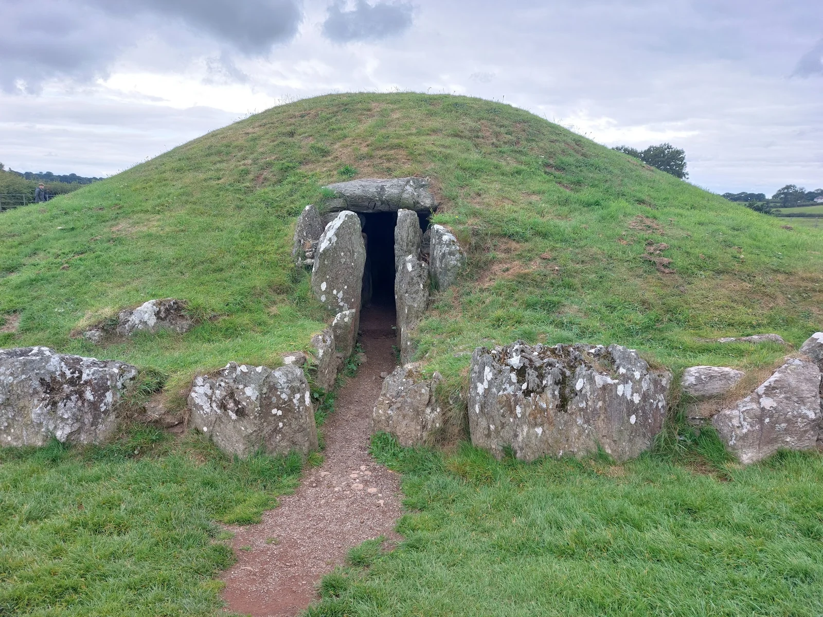 The entrance passage of Bryn Celli Ddu Neolithic burial chamber in Anglesey farmland at dawn