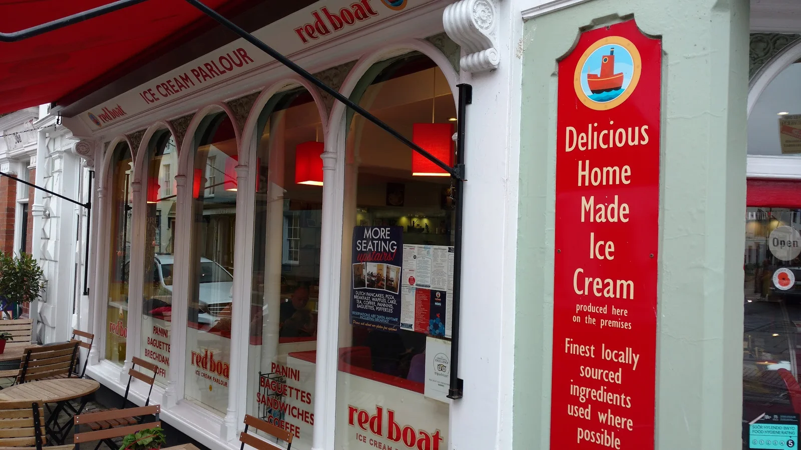 Red Boat Ice Cream kiosk on the Beaumaris pier with the Menai Straits behind