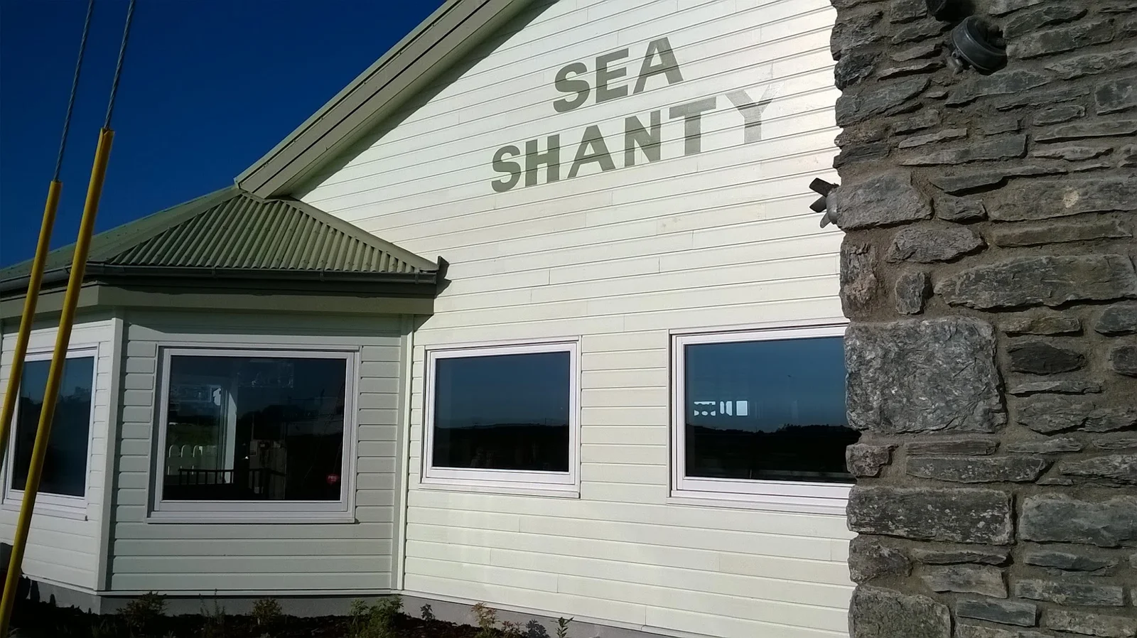 Sea Shanty café terrace at Trearddur Bay with the horseshoe beach behind