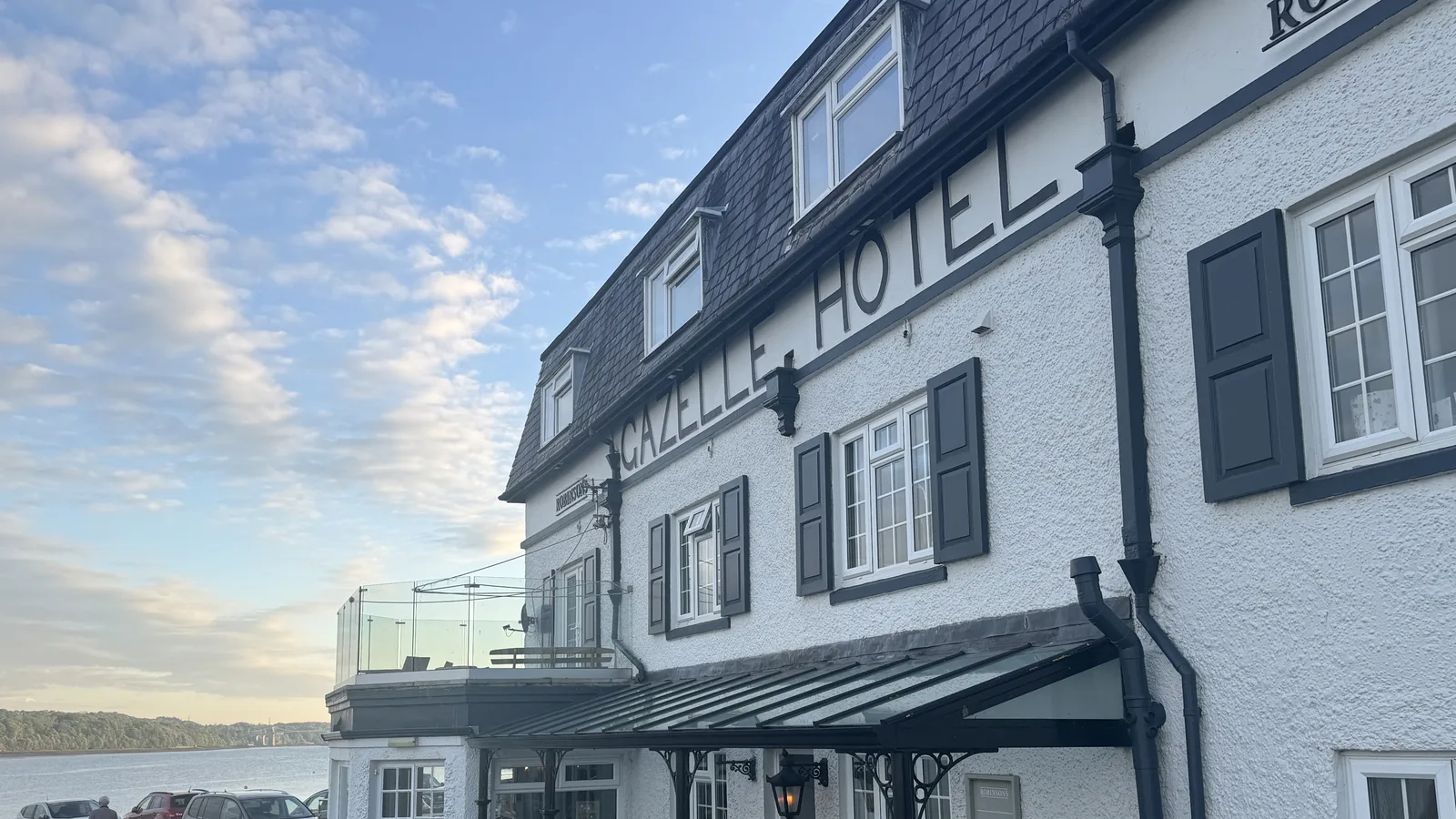 The Gazelle Hotel above the Menai Strait at Glyn Garth, Anglesey, with its waterside terrace at golden hour