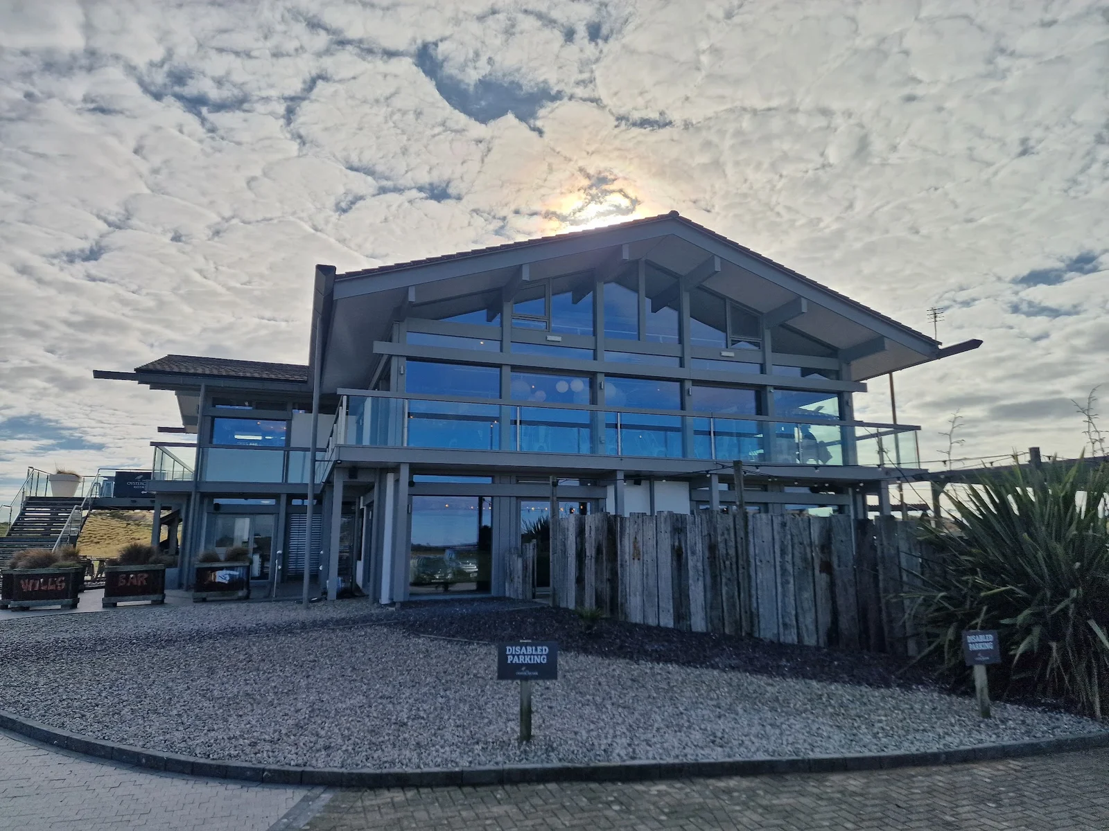 The Oyster Catcher restaurant terrace at Rhosneigr with panoramic Atlantic sunset views over the dunes